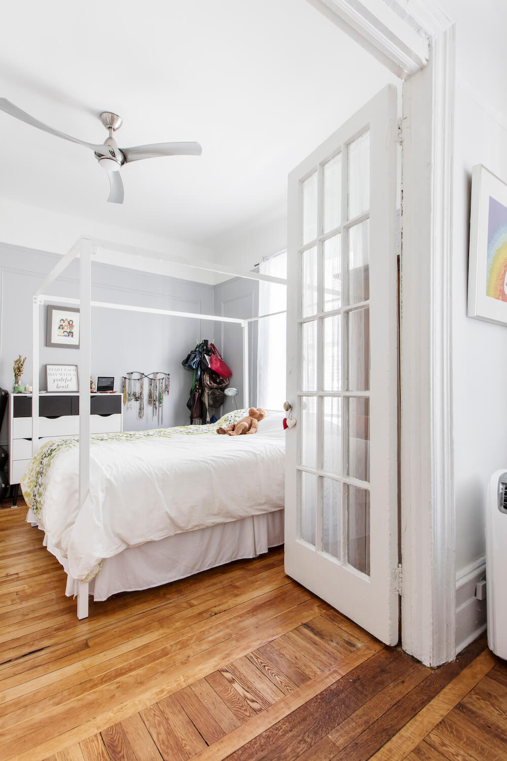 bedroom with french doors and hardwood floors and fan after renovation