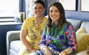 photo of deanna and daria on gray sofa and blue walls  after renovation