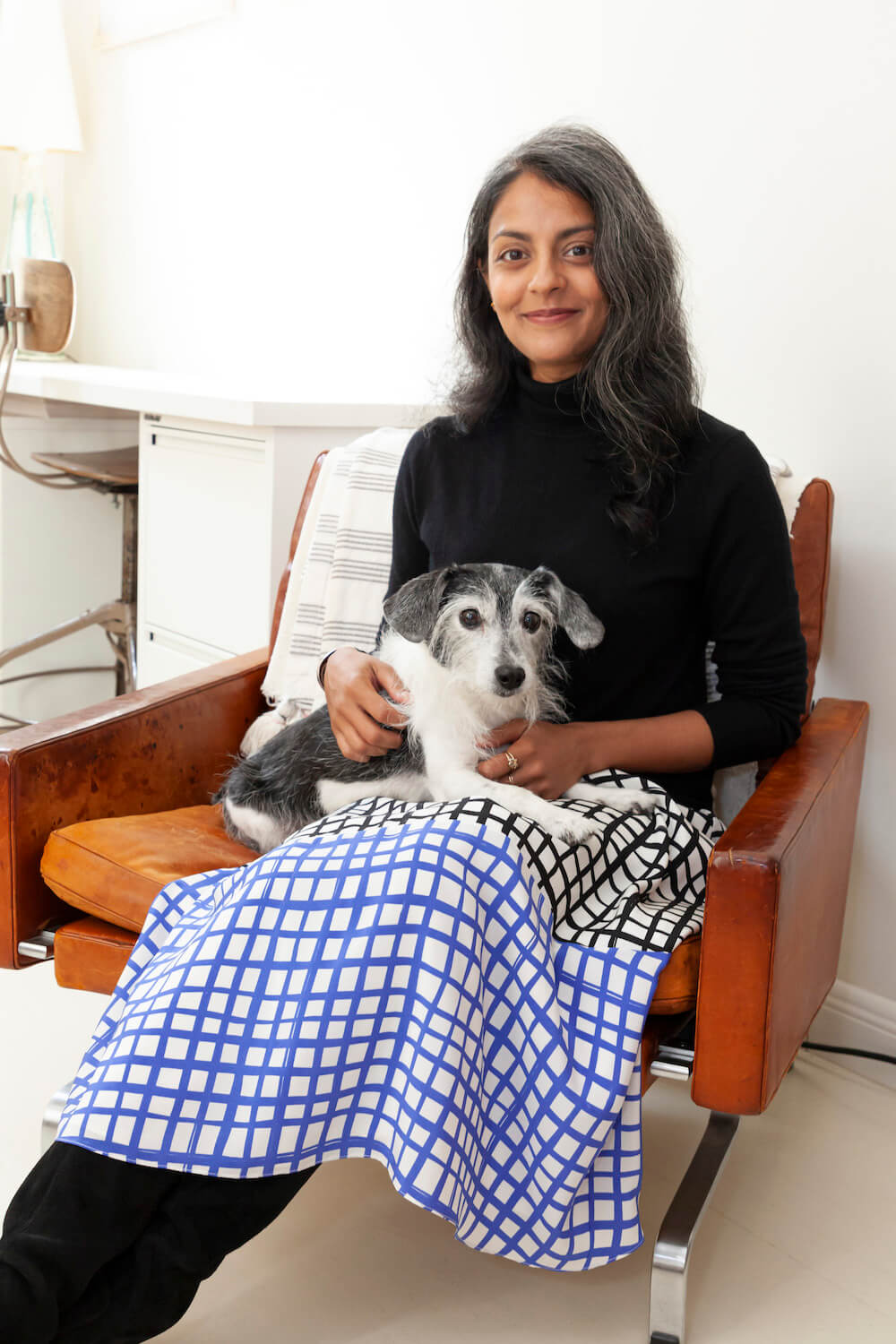 photo of lavanya with her dog on a chair after renovation