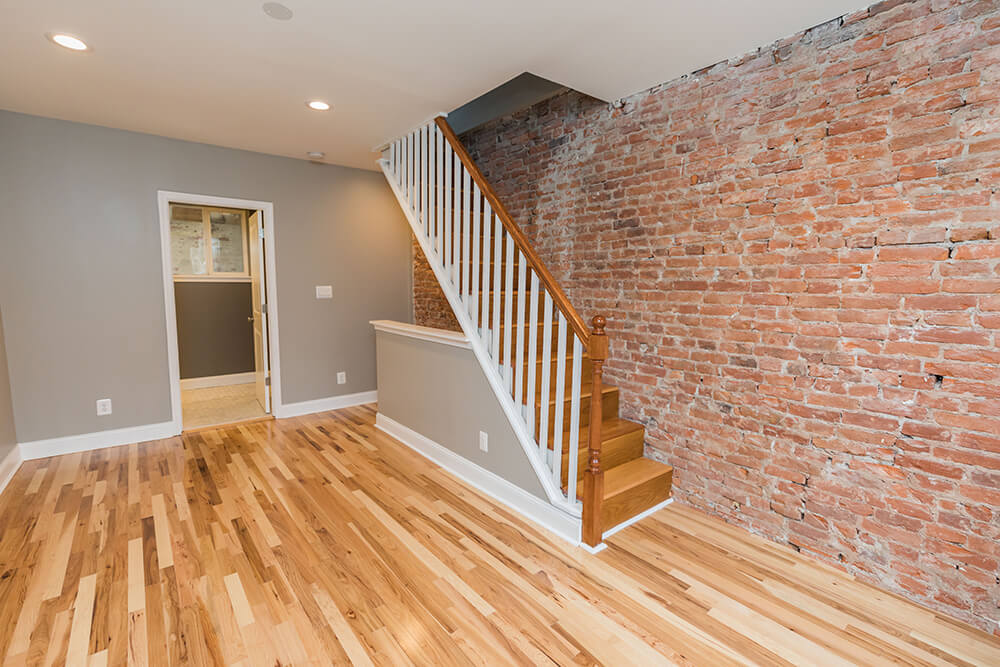 Staircase next to exposed brick wall