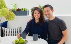 Portrait of Sweeten homeowners Janet and Jerry at a white table drinking coffee