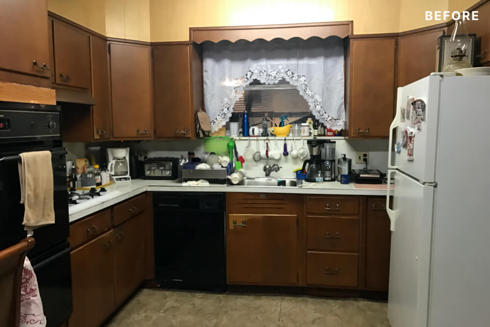 dark brown kitchen cabinets and white countertop before renovation