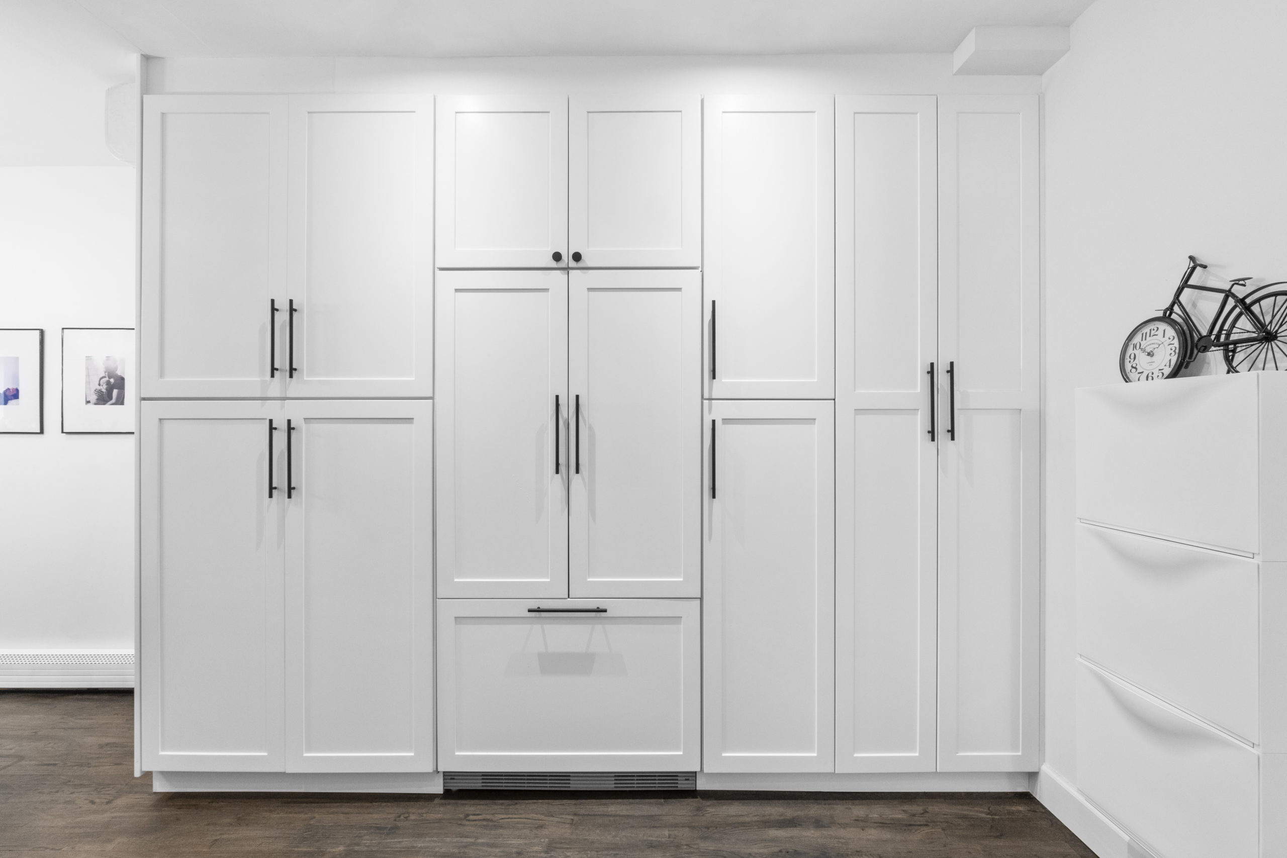 hidden fridge cabinet in kitchen with white built ins