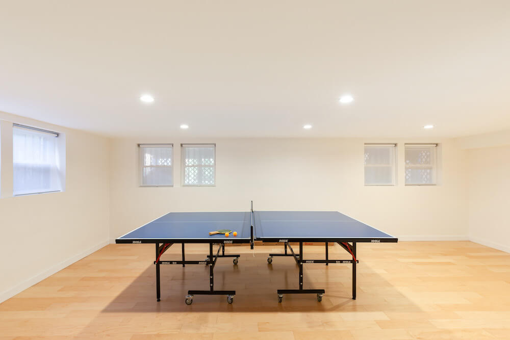 basement remodel with windows and ping pong table