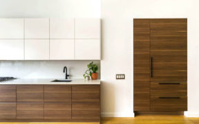 hidden fridge cabinet with paneling in kitchen