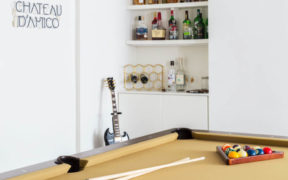 game or music room with in built mini bar and white walls after renovation