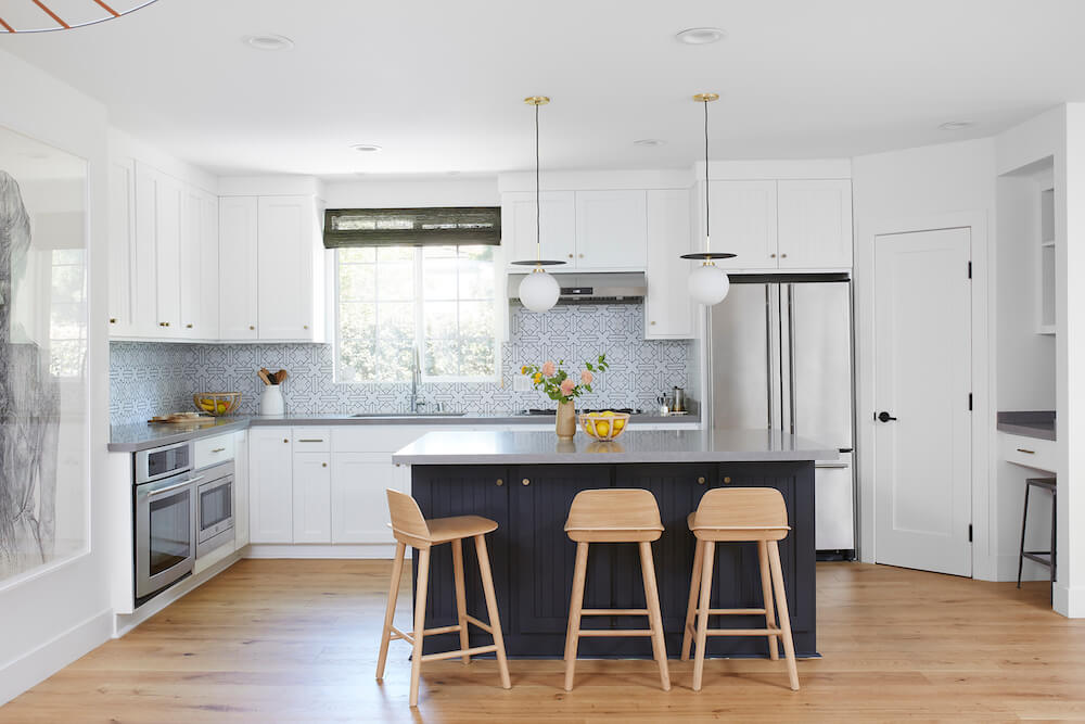 kitchen remodel with black island and white cabinets