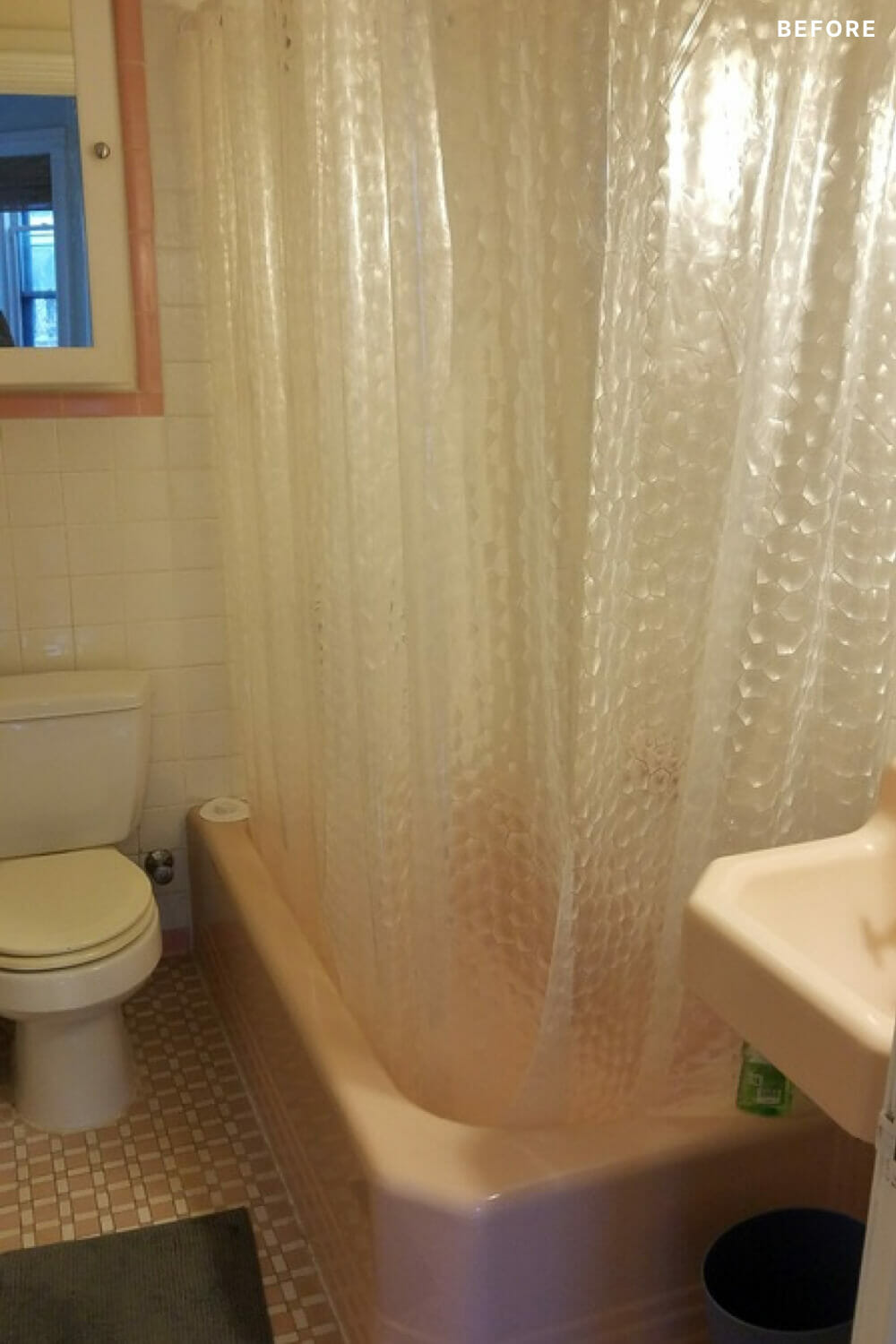 white shower curtain over a pink bathtub and small bathroom with white toilet before renovation