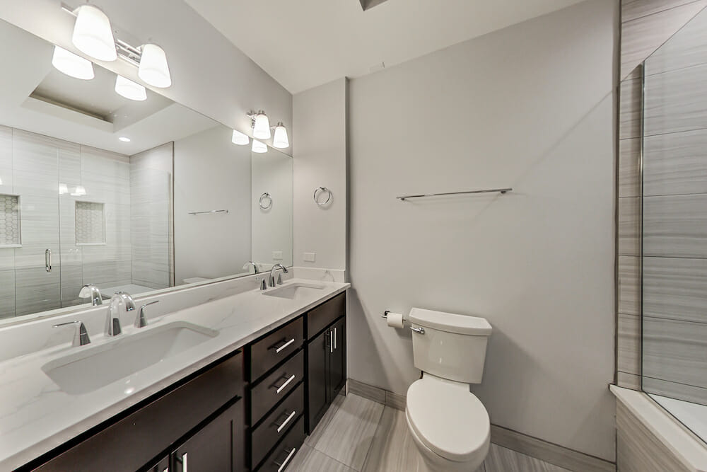 Image of a renovated bathroom in Chicago with double sink and toilet
