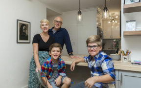 courtney with her family in their kitchen after renovatqion