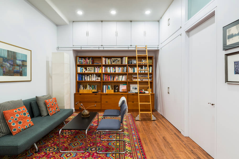 Image of living room with bookcase wall and ladder