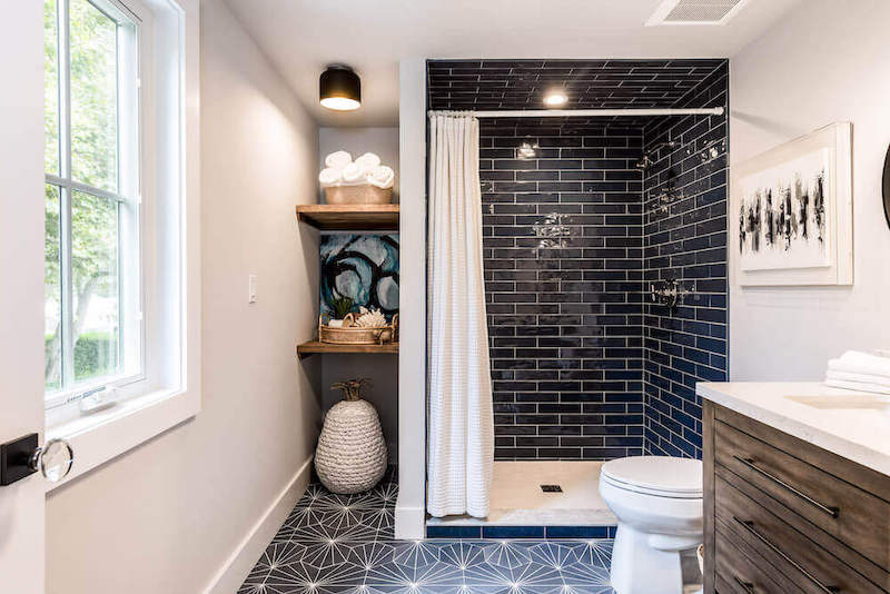 bathroom with black subway tile in the shower
