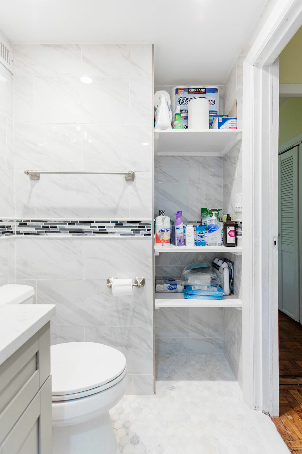Image of a built-in bathroom storage nook with supplies