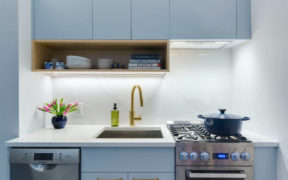kitchen with light blue cabinets brass finish