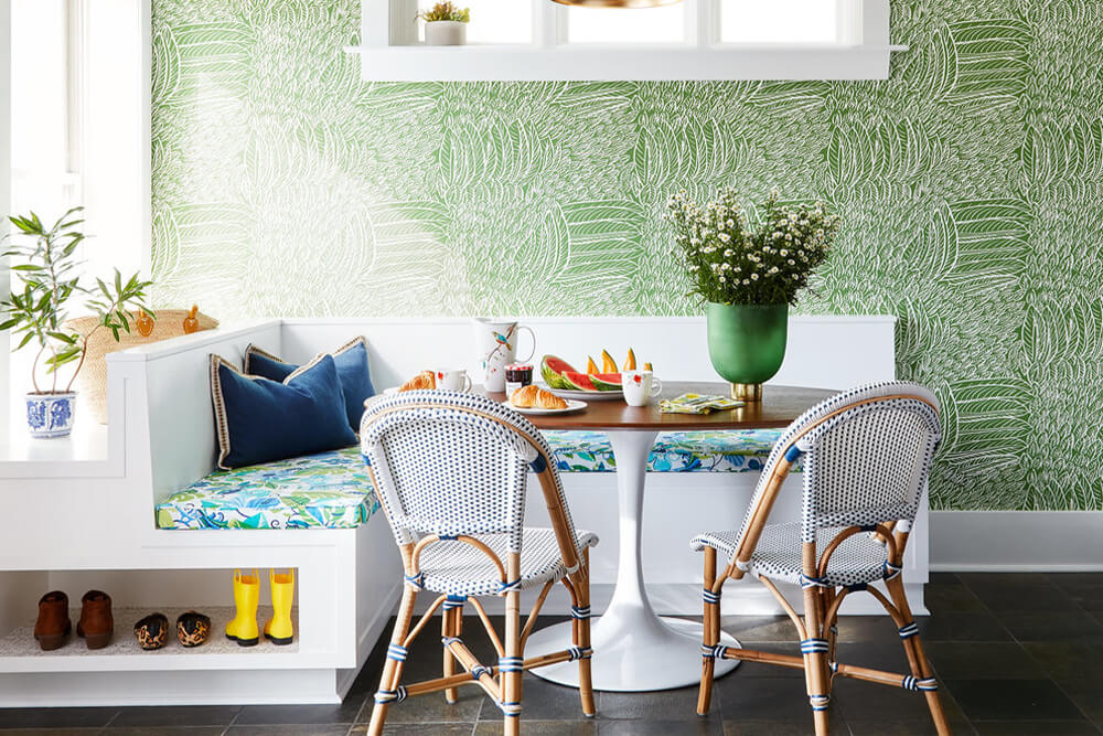 tiny breakfast nook with round table and chairs and green wallpaper after renovation