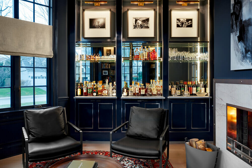 bar area with black cabinets and black leather chairs and long panelled glass windows after renovation
