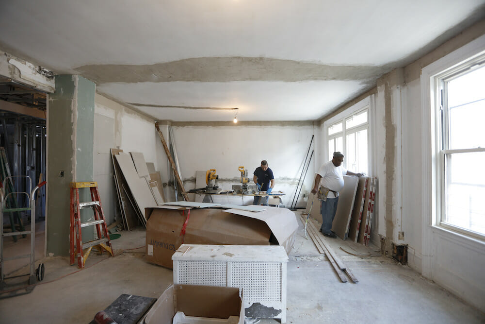 workers remodelling a living room during renovation