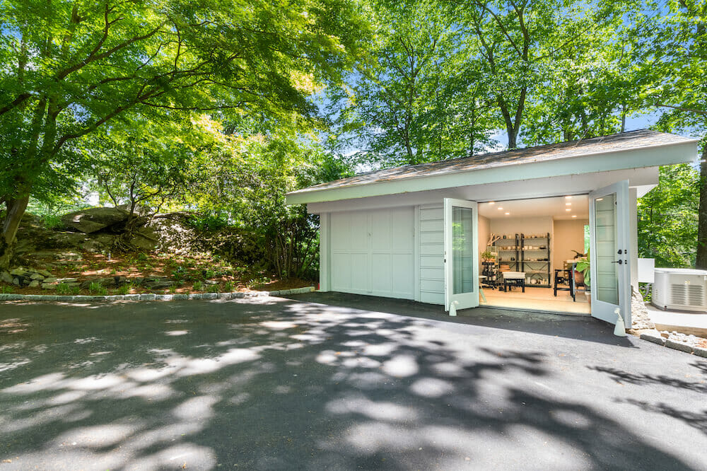 one part of two car detached garage converted to room and sectional door replaced with see through glass doors during renovation