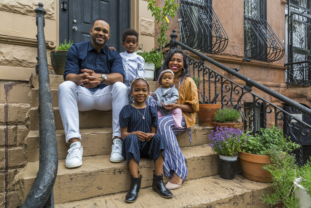 Homeowners with their children outside the brownstone