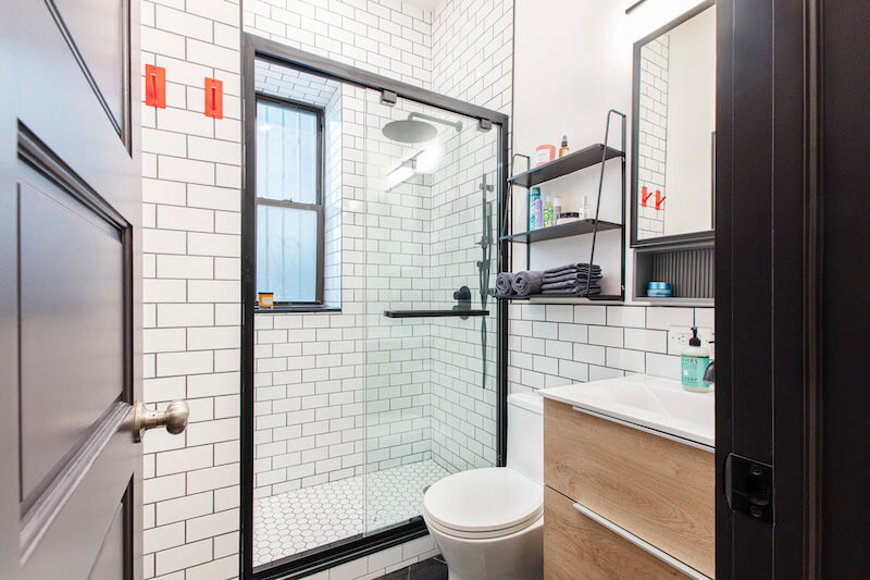 small bathroom with walk-in shower and vanity and built-in medicine cabinet after renovation