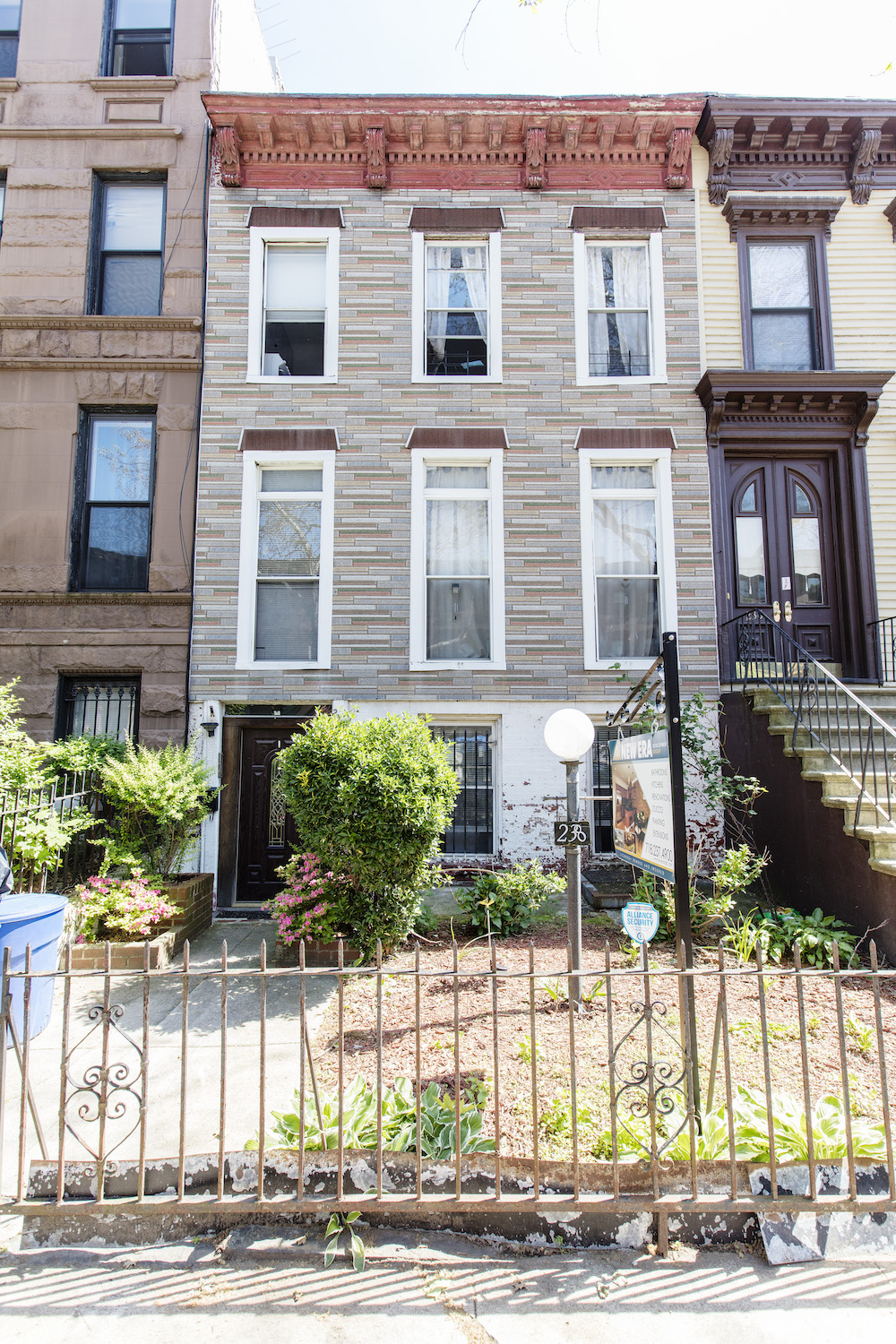 remodeled townhouse facade with brick exterior and wooden trims after renovation