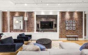 Brick hightlight wall in a living room complete with furniture after renovation