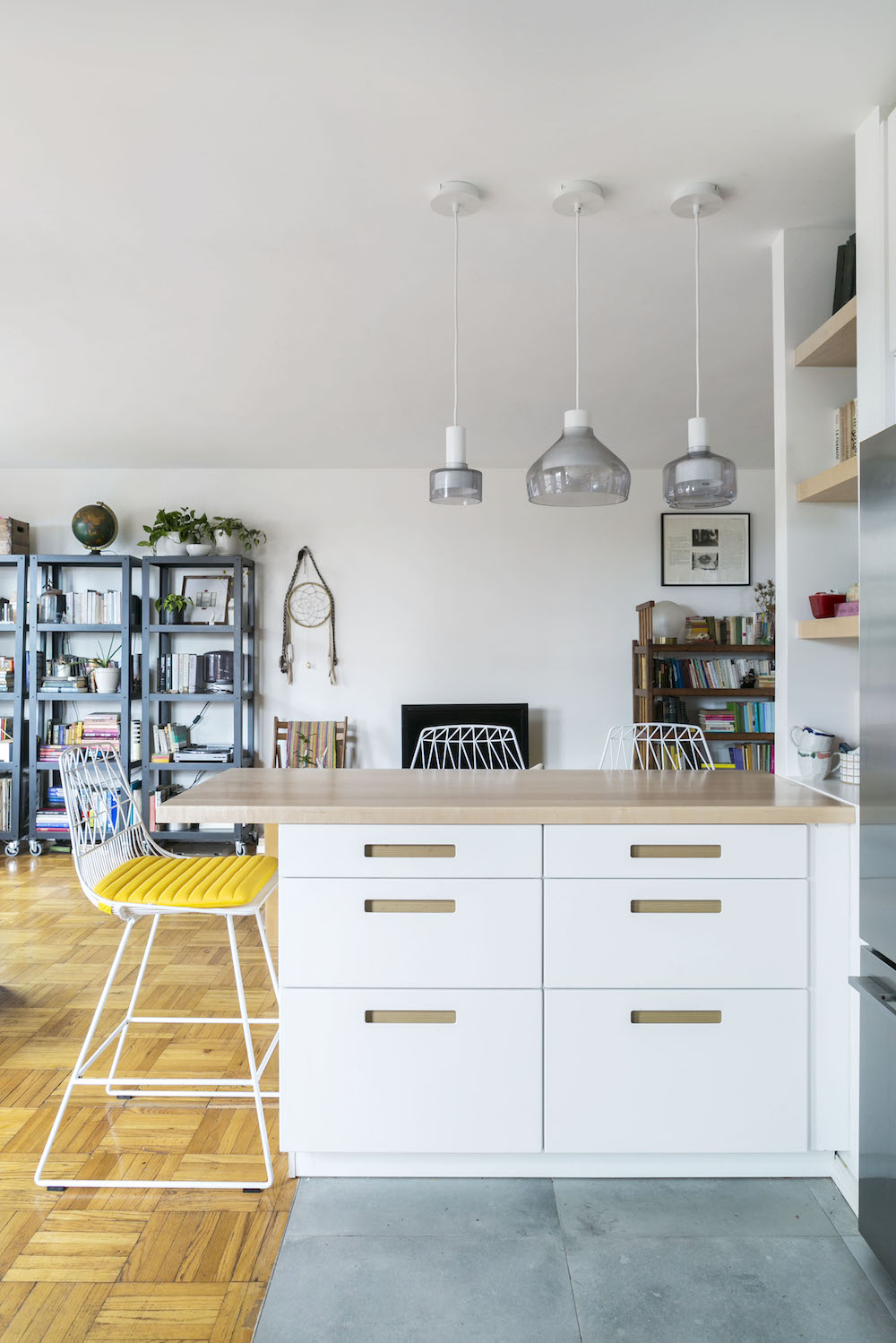 White built-in storage cabinet within the kitchen peninsula
