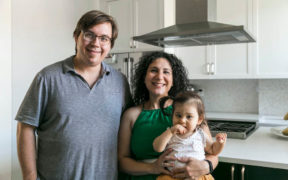 Portrait of Sweeten homeowners and baby in their renovated kitchen