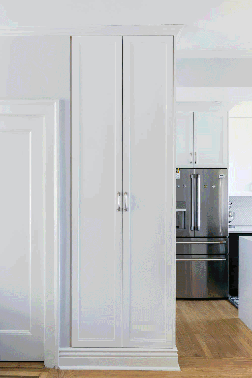 Built-in kitchen closet storage with doors opening and closing