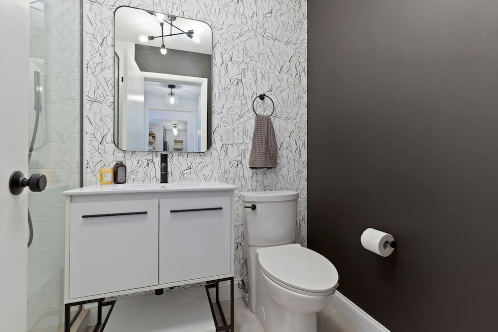Bathroom with black and white walls and vanity