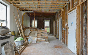 Apartment during a renovation with exposed ceiling and walls