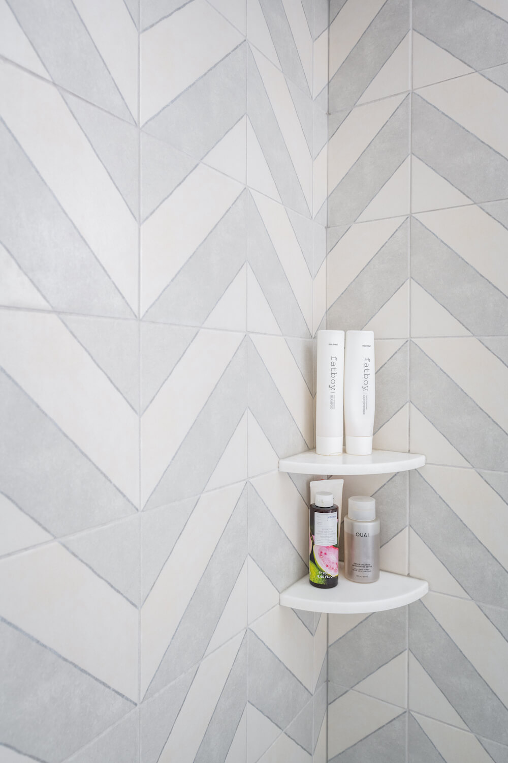 Chevron tiles in the shower with built in shelving