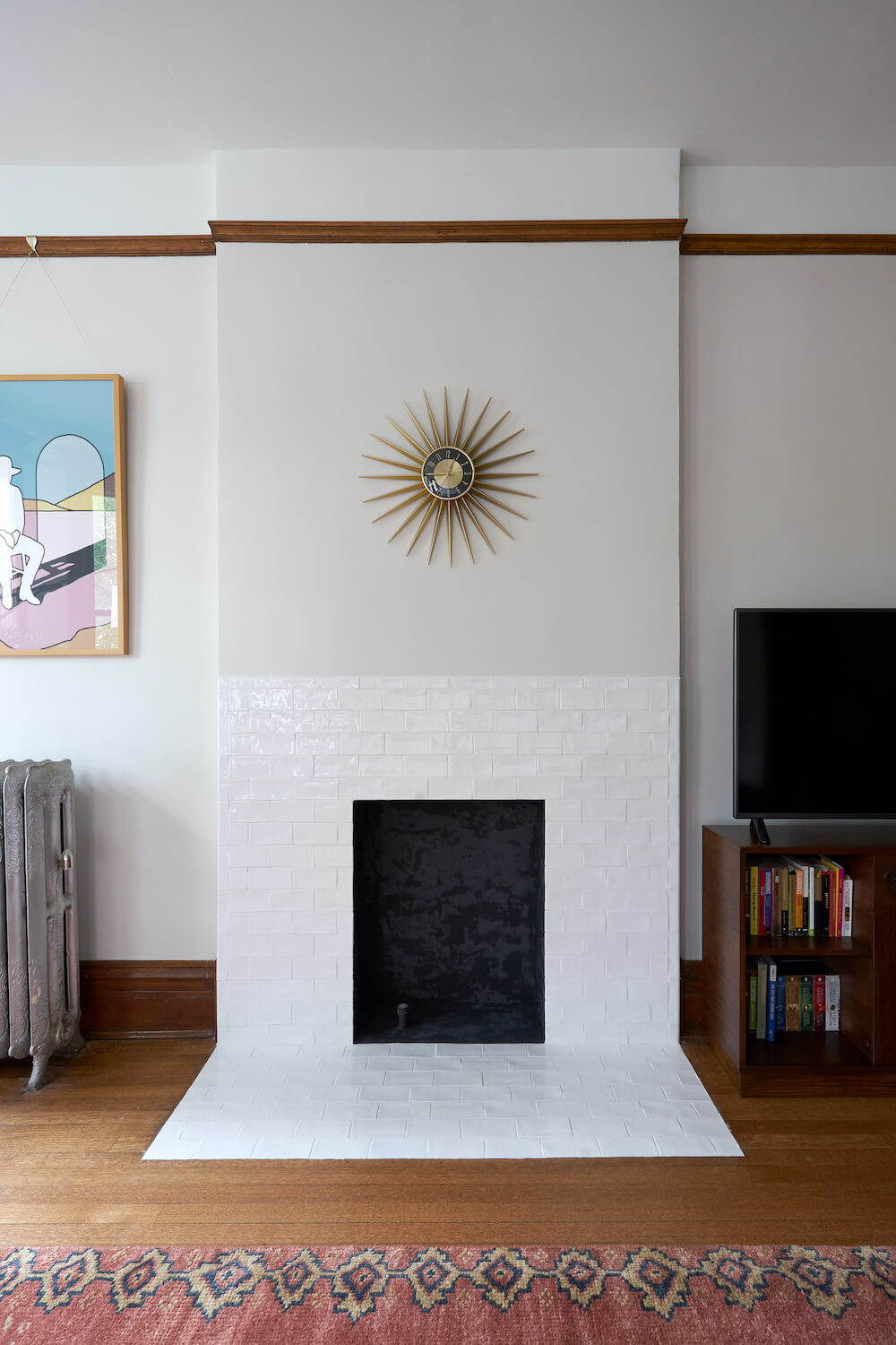 White tiled fireplace with decorative clock above