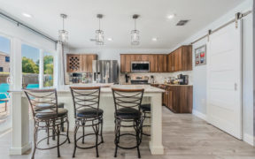 Kitchen with white island with seating