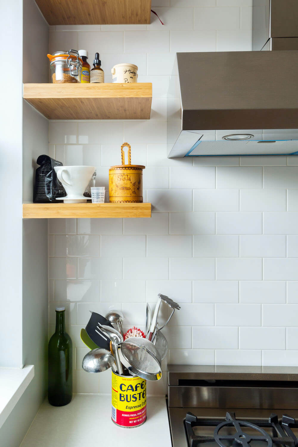 White tile backsplash and wood shelves