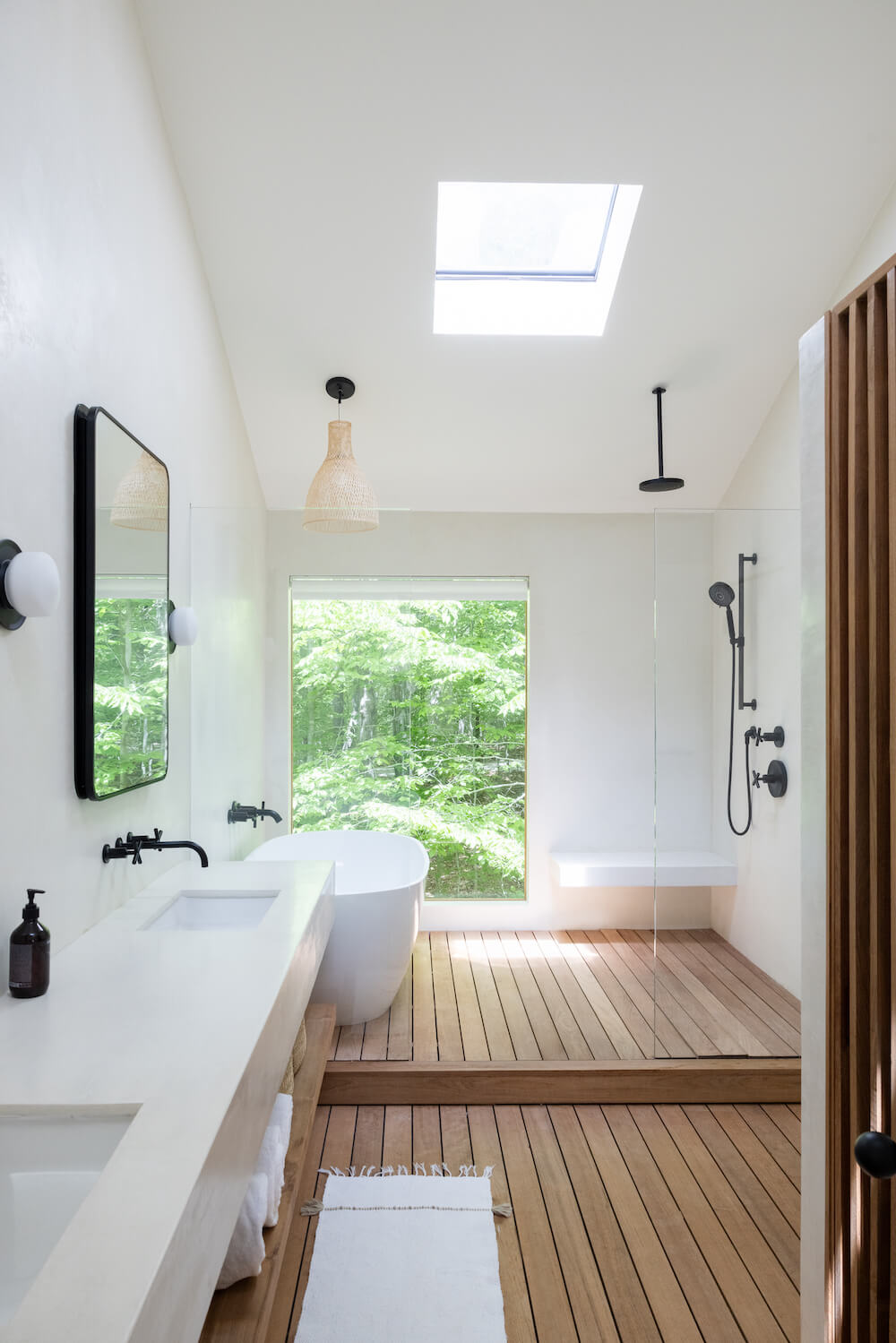 Master bath with wooden floors and white tub