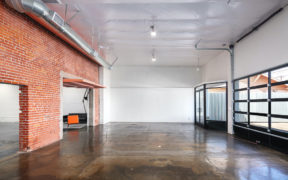 Entryway with glass doors and red brick wall
