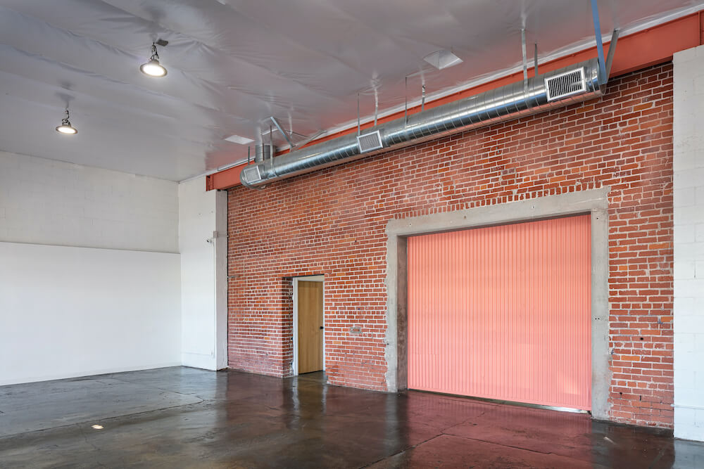 Interior with red brick wall and high ceilings