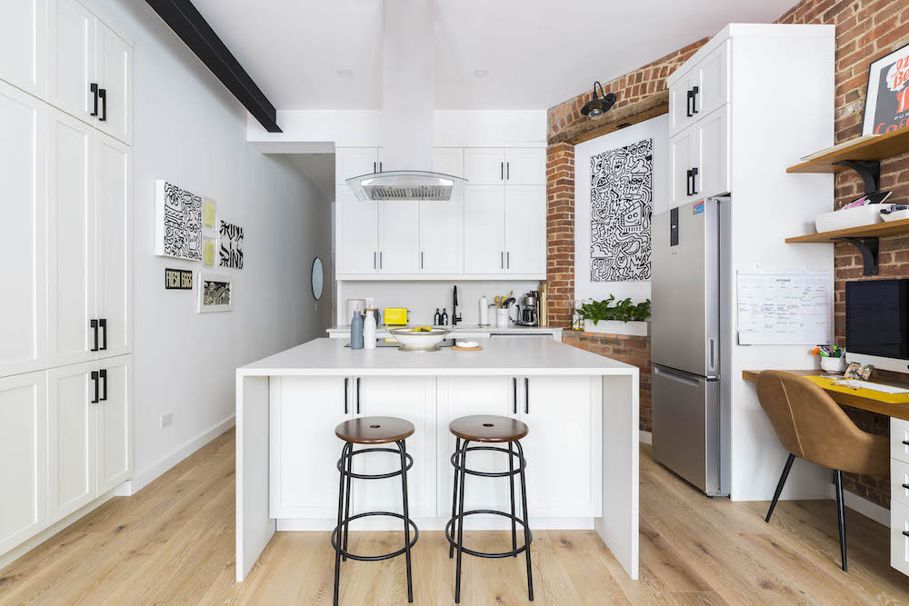 white and brick kitchen with island with seating