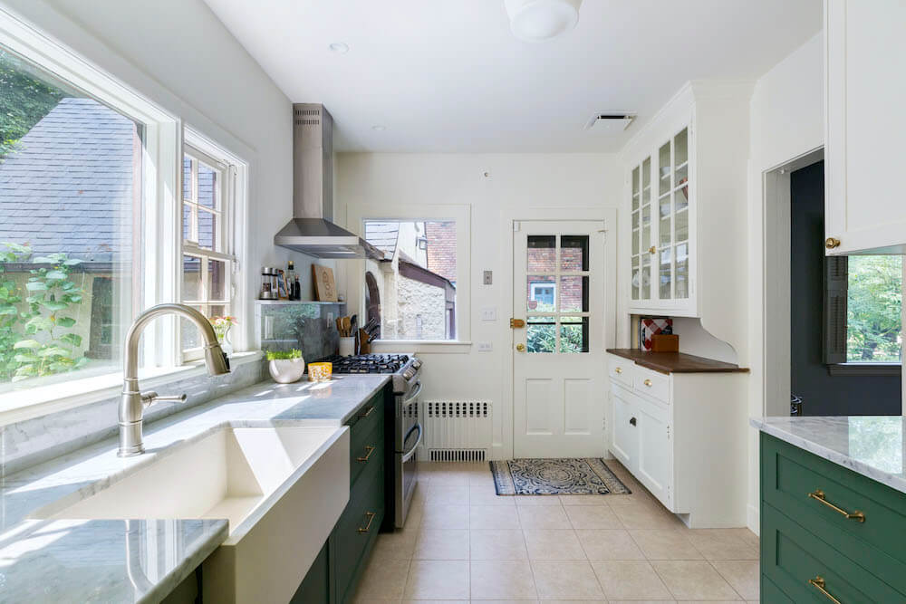 green kitchen cabinets with door leading outside