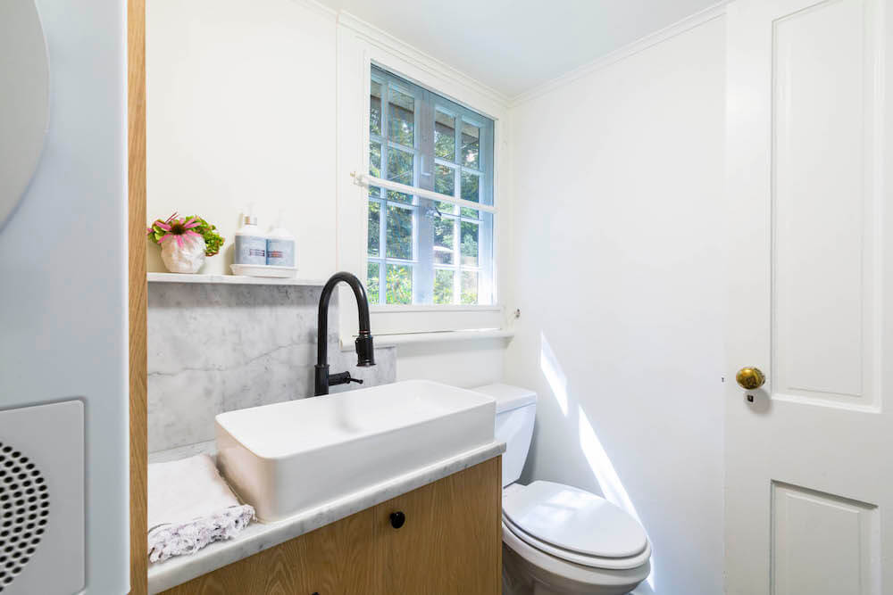 Bathroom sink with white basin sink and wood vanity