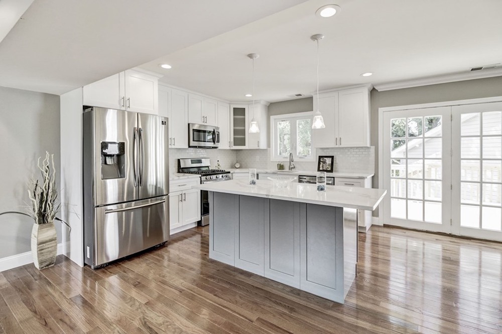 Kitchen with wood floors and white cabinets