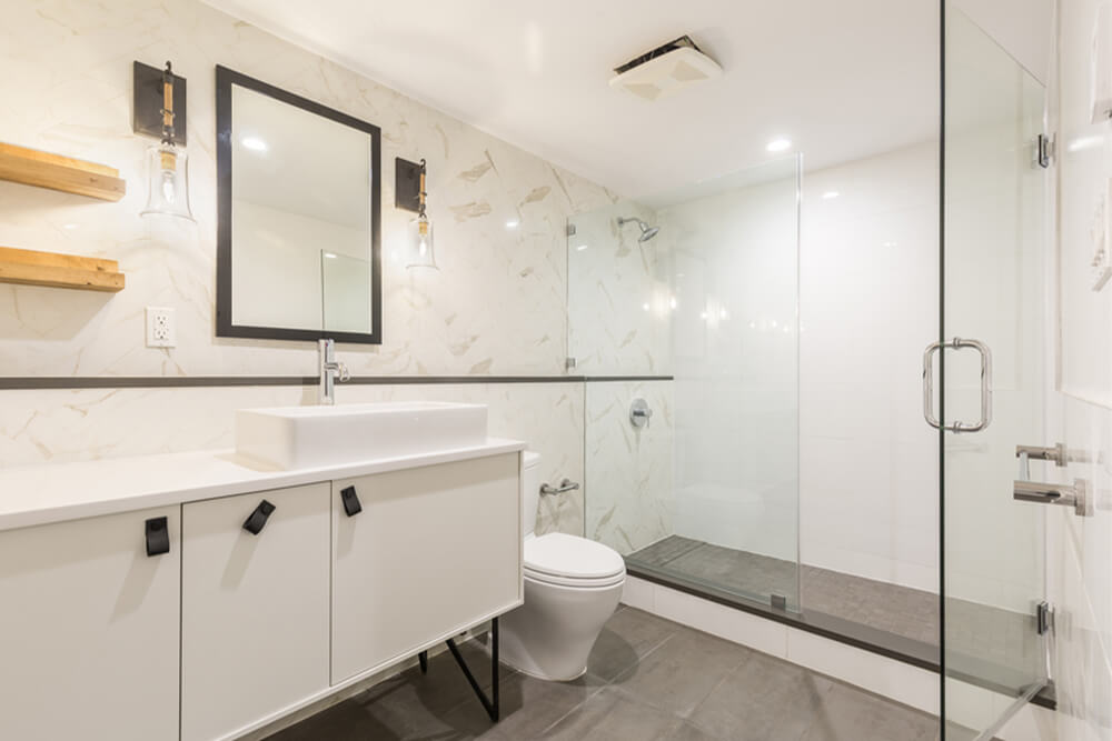 Bathroom with white marble walls and granite floors