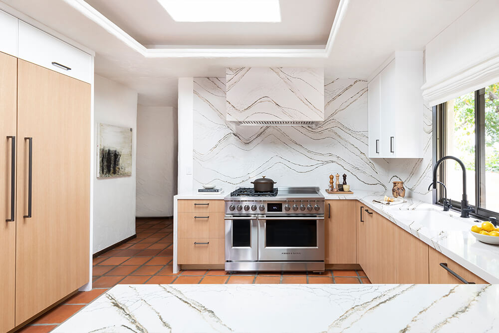 Kitchen with marble counters and wooden cabinet panels