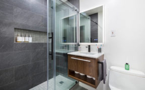 Bathroom with gray shower and floating vanity