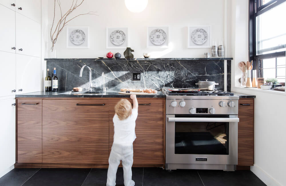 Kitchen with wooden cabinets and dark marble backsplash