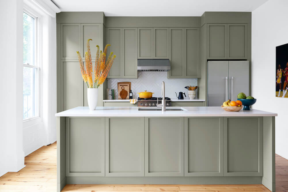 Kitchen with olive green cabinetry and island
