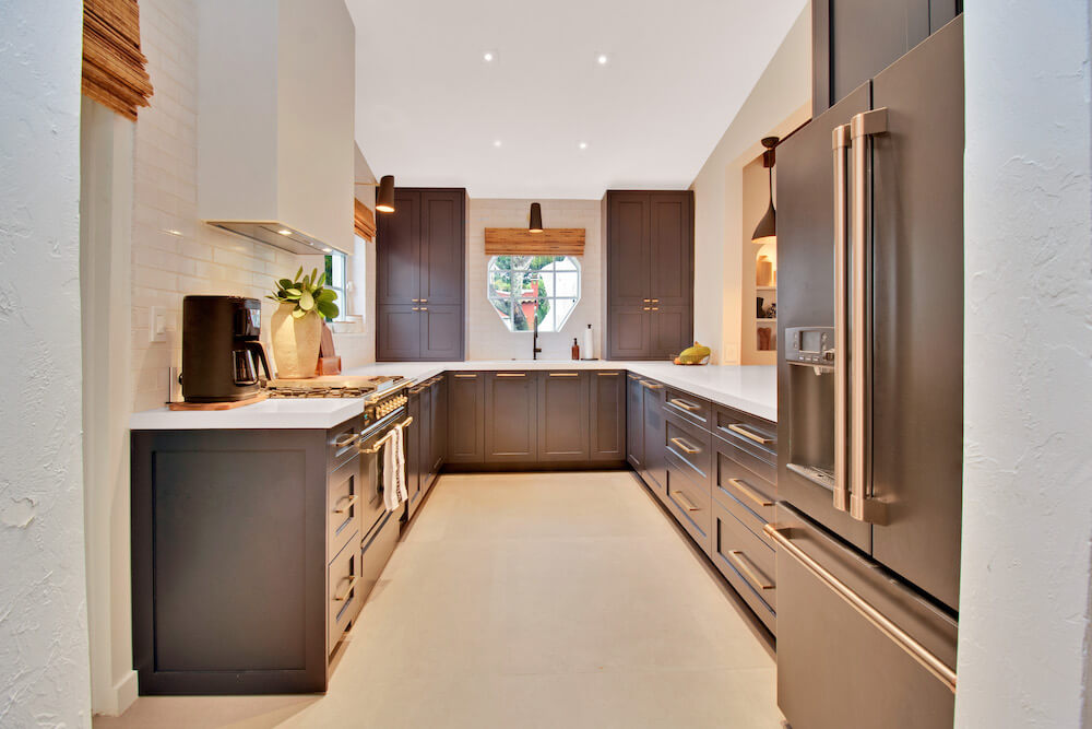 Kitchen with dark gray cabinets and white countertops