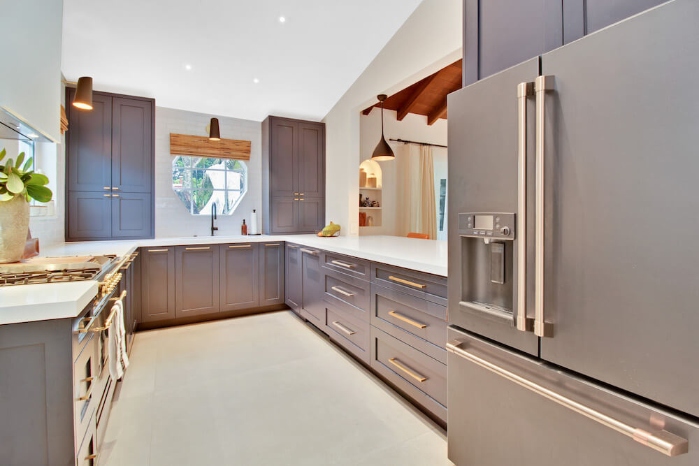 Galley kitchen with stainless steel refrigerator