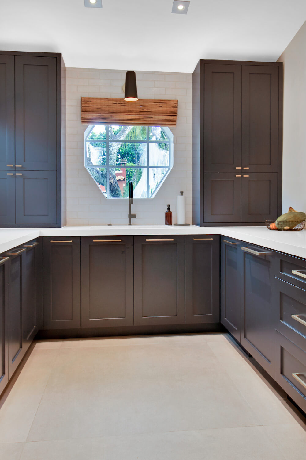 Kitchen with dark gray cabinets and white counter